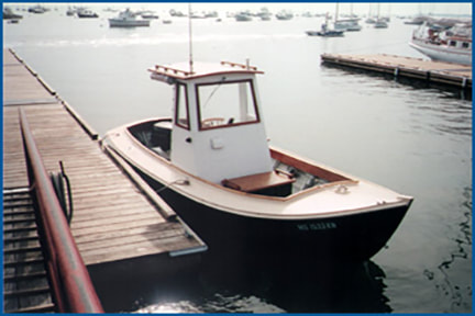 20 foot wooden simmons sea skiff power boat built by South Shore Boatworks at dock