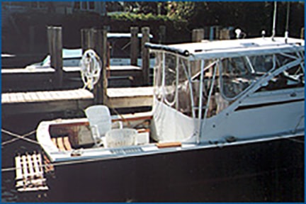 27 foot nauset downeast power boat restored and refit by South Shore Boatworks at dock