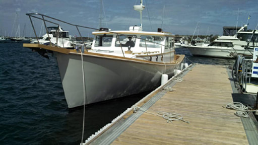Twist wooden downeast power yacht boat at dock restored and refit by south shore boatworks