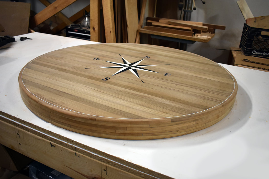 Nautical round wooden table top with compass rose inlay built in teak by South Shore Boatworks