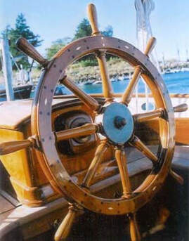 varnished wooden yacht ship steering wheel on sailing yacht catriona helm with engraved bronze hub built by south shore boatworks 
