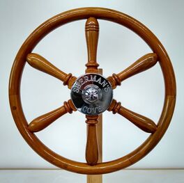 varnished wooden powerboat wheel for sherman's cove with chromed bronze hub engraved built by south shore boatworks from teak with rim and spokes