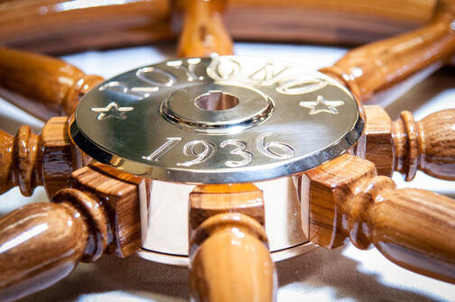 steering wheel for 1936 royono sailing yacht with teak wood spokes and engraved polished bronze hub with stars built by south shore boatworks