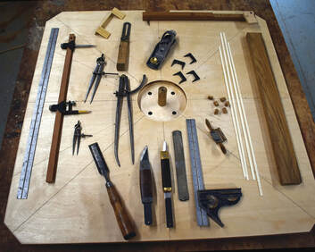 Tools on shop bench that are required to build a wooden ship yacht or boat steering wheel at south shore boatworks