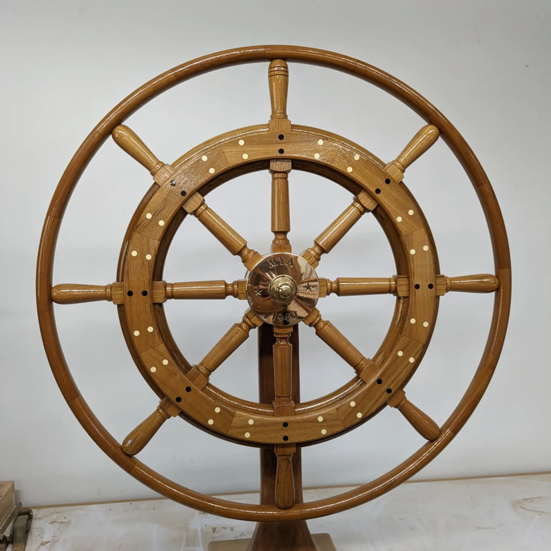 Sailing Yacht Concordia Schooner Mya's new traditional wooden steering wheel built by south shore boatworks with a bronze engraved hub