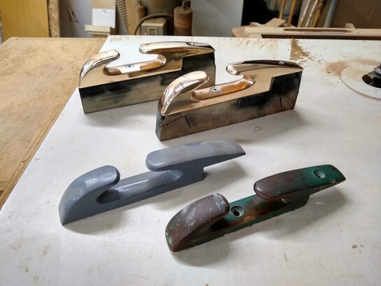 Polished cast bronze chocks and wooden foundry patterns made by South Shore Boatworks