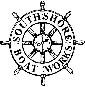 south shore boatworks logo a black and white traditional wooden ships wheel with a compass in the middle and words on the rim