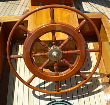 wooden yacht steering wheel helm on sailing yacht glide with varnished finish and bronze hub engraved built by south shore boatworks